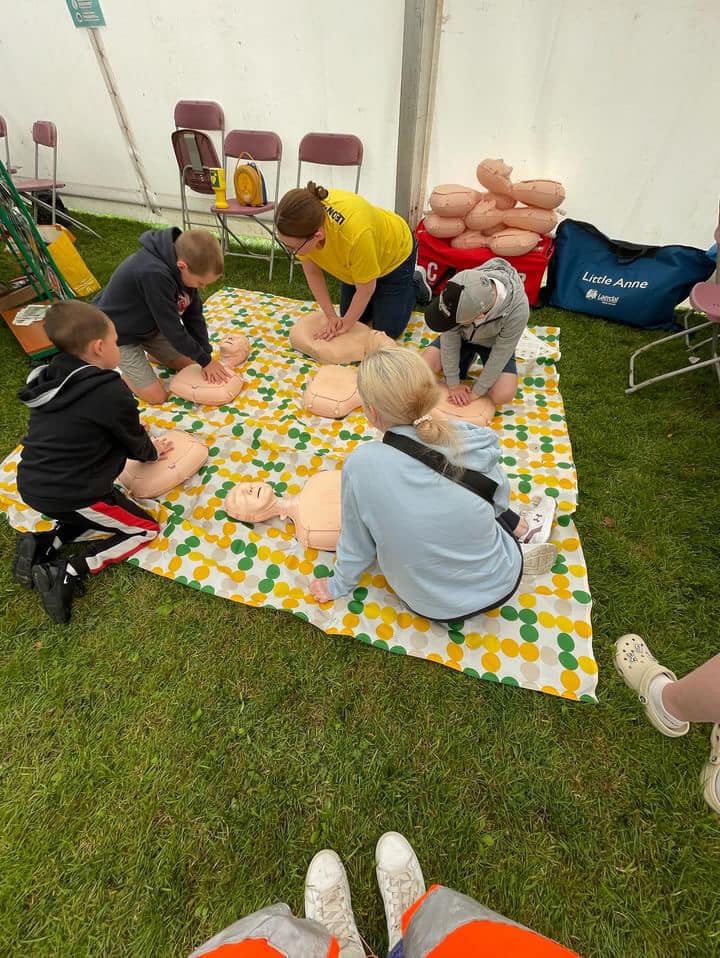 Children practicing CPR on resuscitation dummies