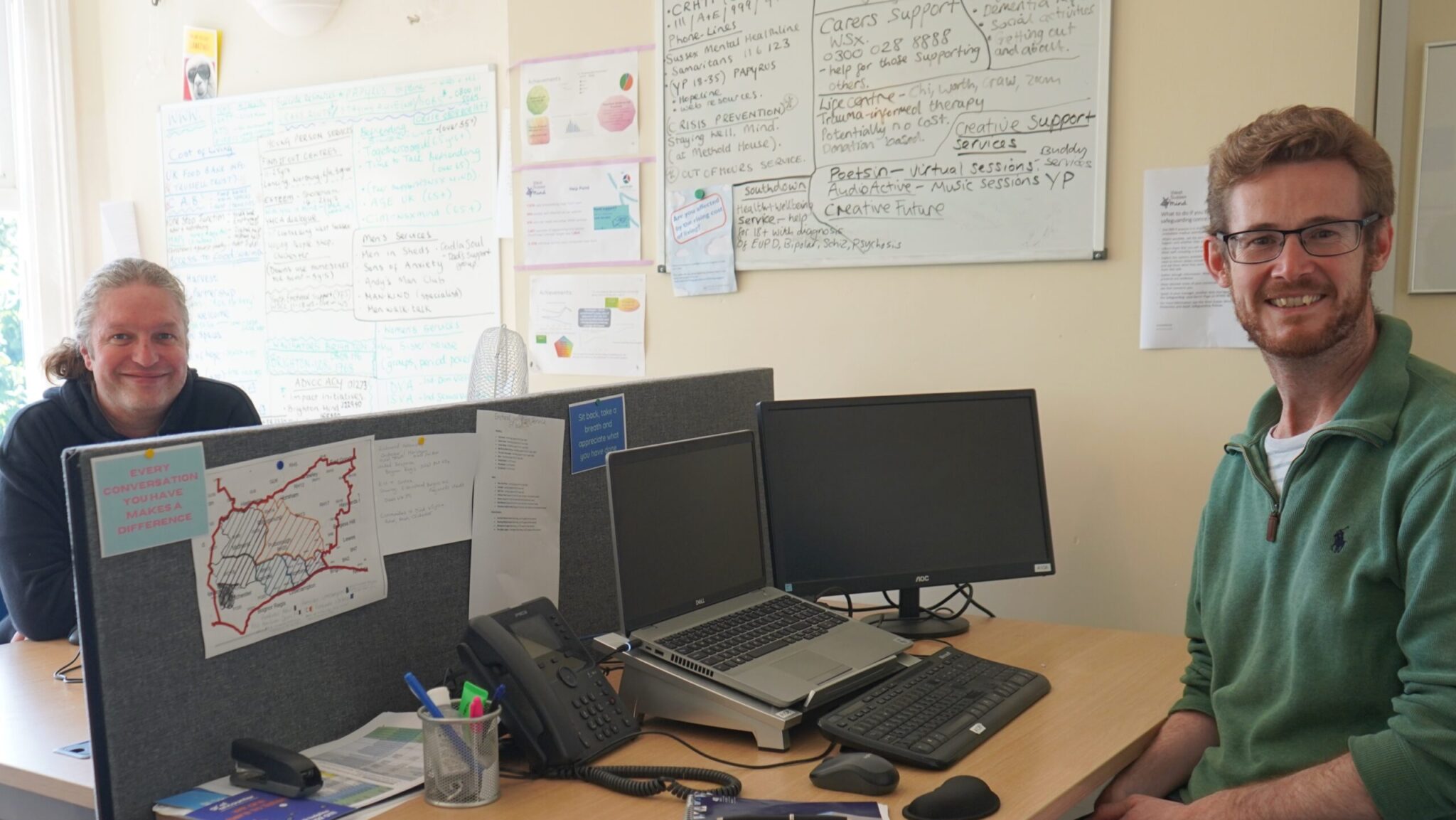 2 staff members manning the help point sat at their desks