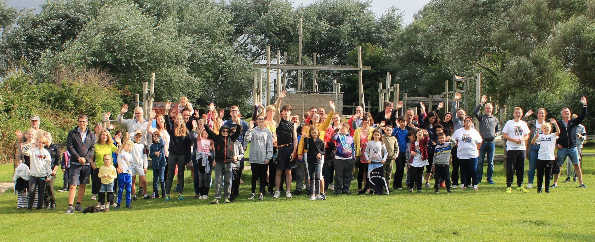 A large group of people stood in front of an adventure park
