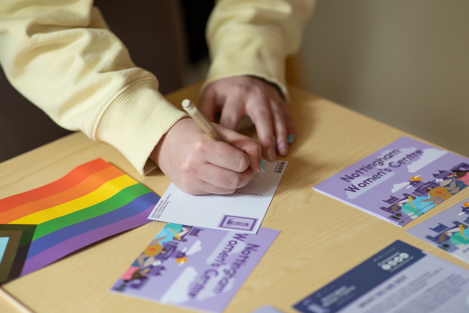 Writing a postcard at the Nottingham Women's center