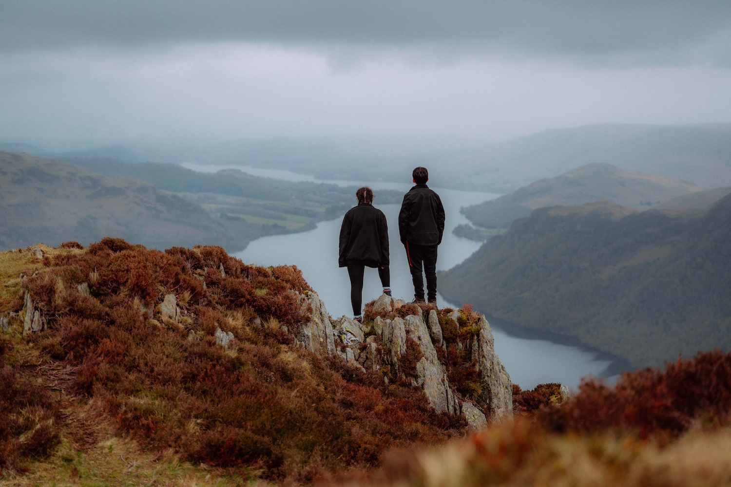 2 people staring across a landscape with a river inthe distance