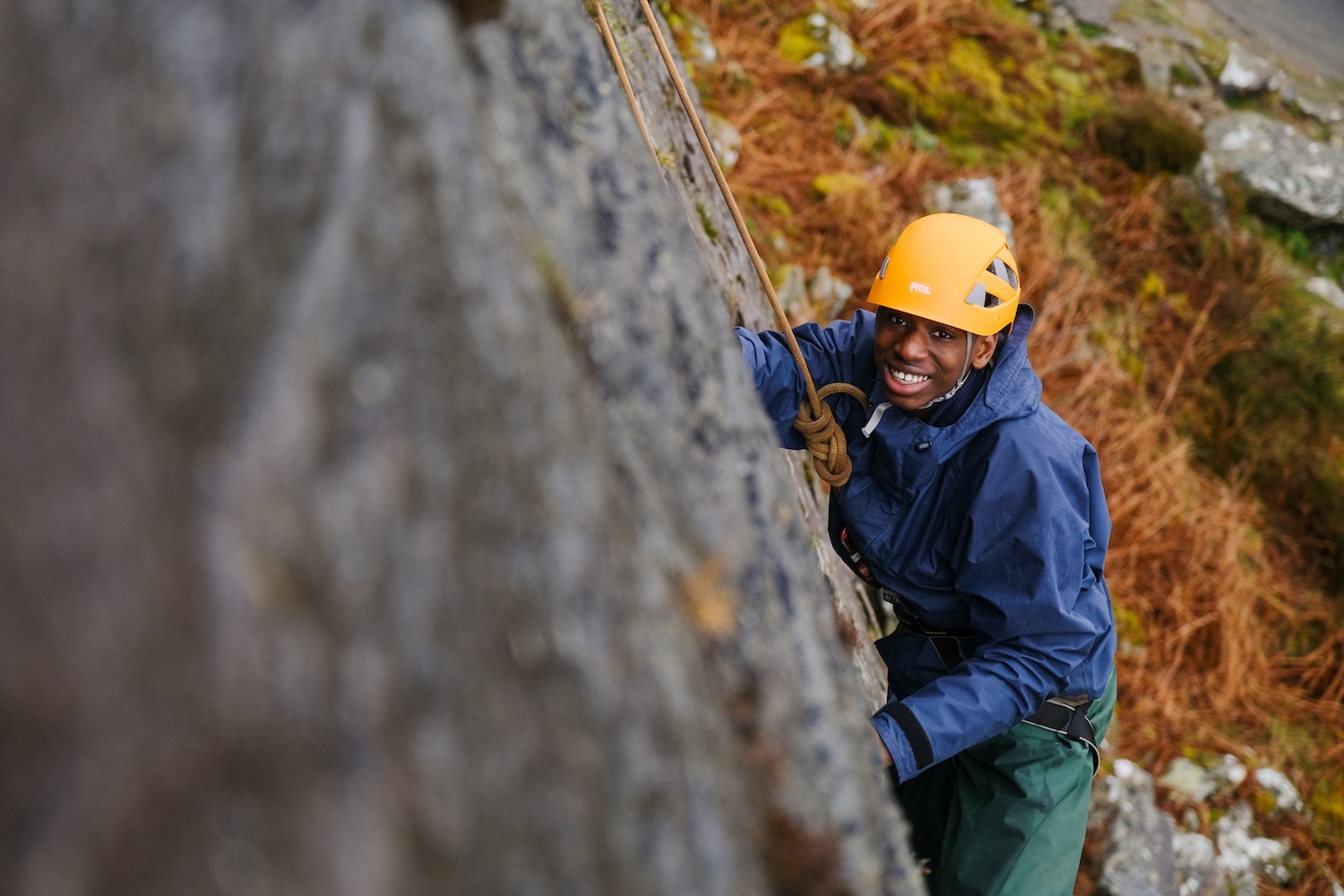 A young person climbing with ropes