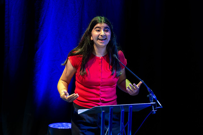 Young person speaking on stage